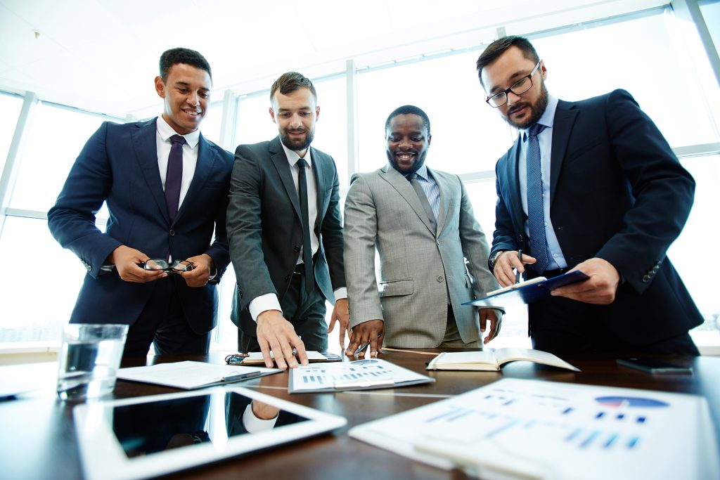 Confident businessmen analyzing financial documents